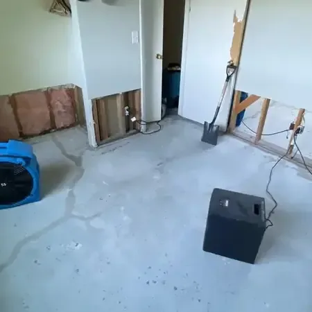 Chanhassen water damage restoration: air movers and a dehumidifier drying a stripped room
