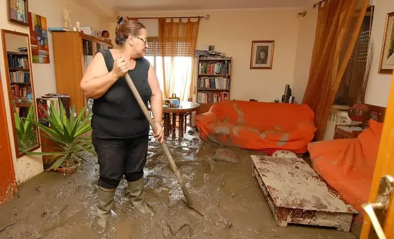Muddy floodwater spread across a living room floor